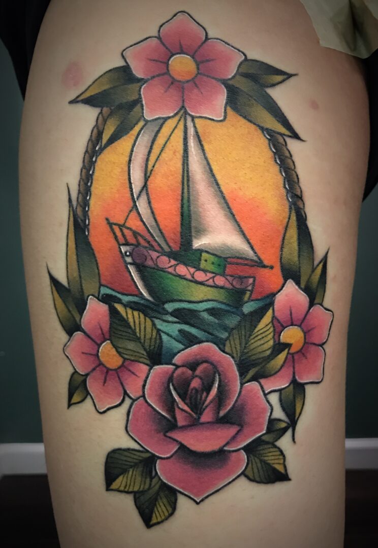 A stunning tattoo featuring a sailing boat set against an orange background, surrounded by pink flowers and green leaves—a perfect design choice for those seeking unique tattoos in St. Louis.