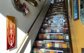 A staircase with multicolored tile accents