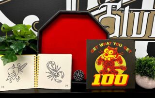 Notepad with pierced heart and scorpion illustrations