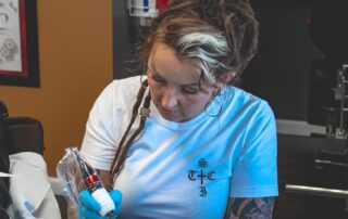 Artist tattooing an arm
