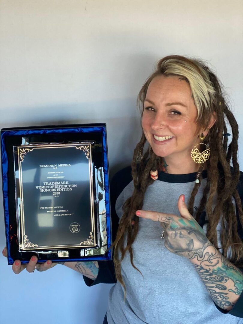 Tattoo artist holding a plaque